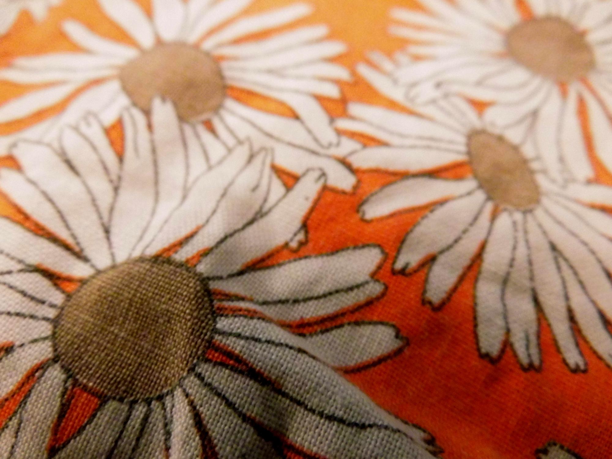 Close-up of embroidered floral patch on linen